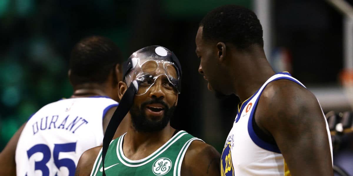 Kyrie Irving et Draymond Green discutent pendant un match entre les Celtics et les Warriors.